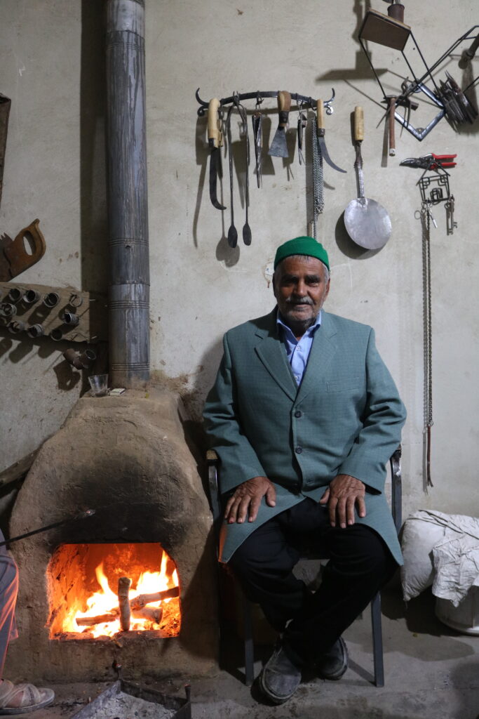 A moghanian next to the fireplace with qanat tools